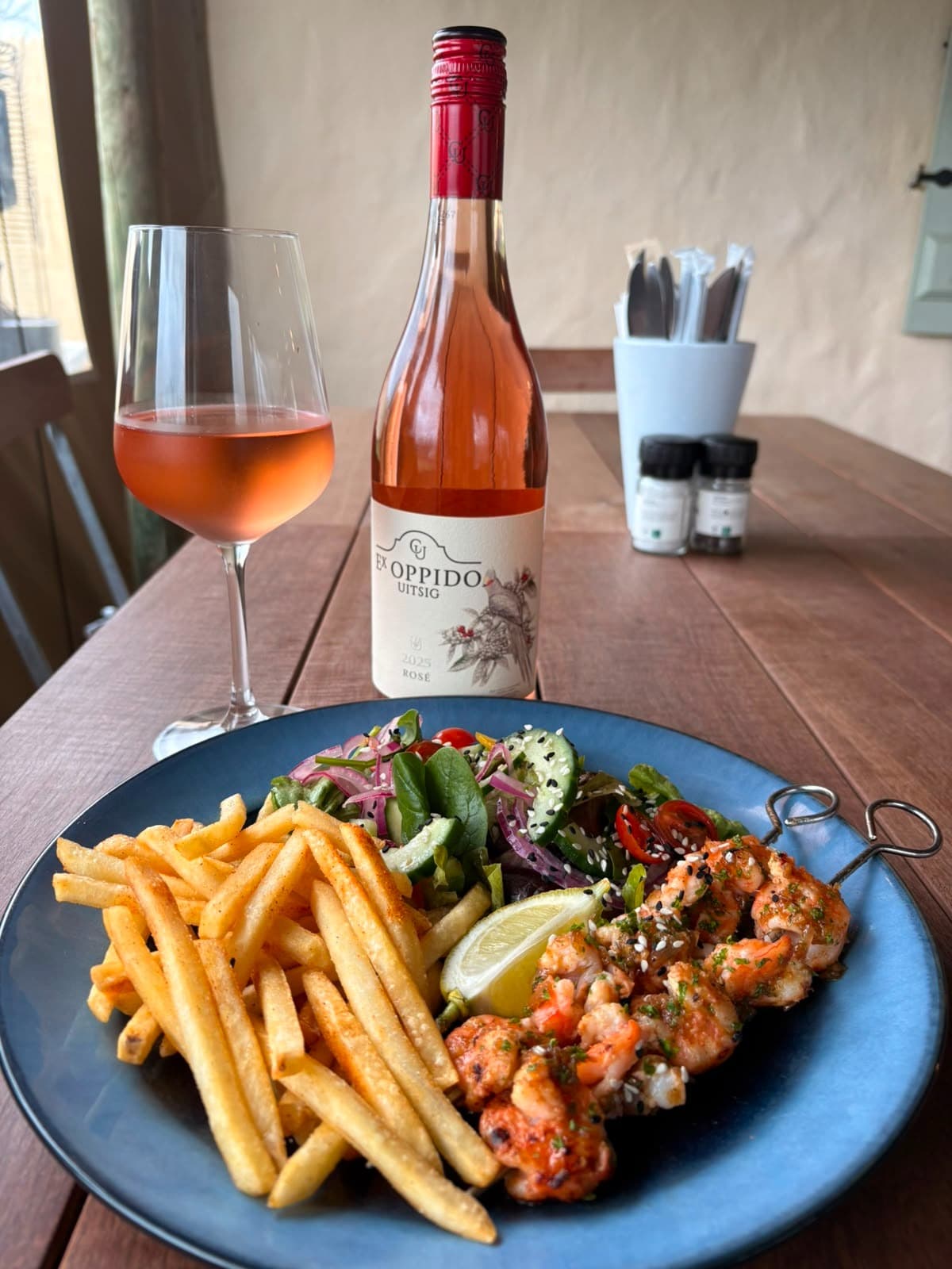 Prawns, fries, salad, and rosé